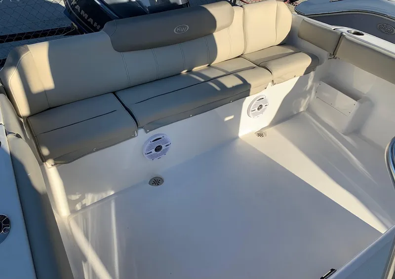 Slide: The Image of 2024 Key West 239 FS boat with beige seating and built-in speakers. - 4