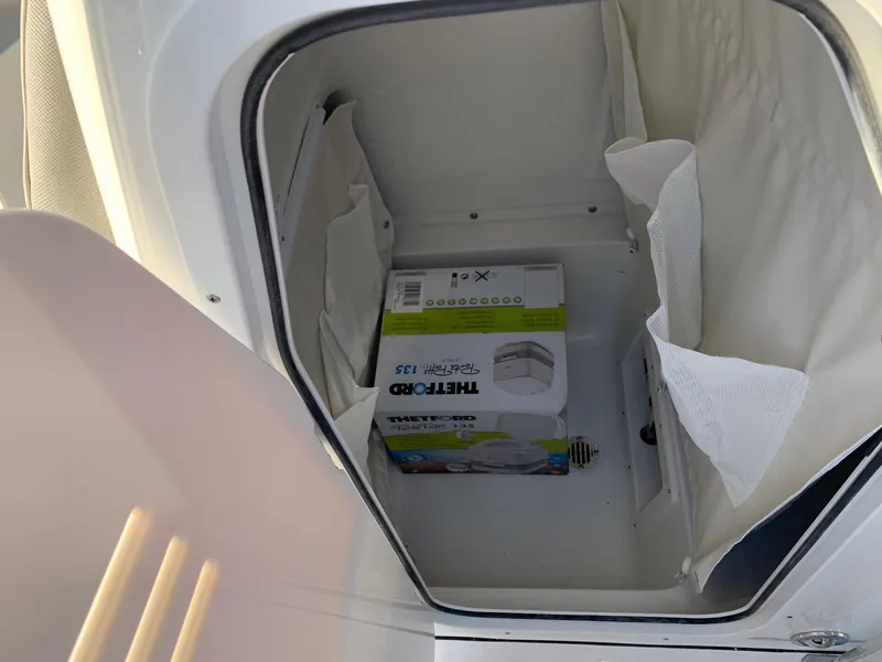 Slide: The Image of Storage compartment of 2024 Key West 239 FS boat with a ThermoPro box inside. - 6