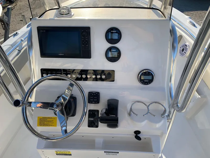Slide: The Image of 2024 Key West 239 FS boat console with steering wheel, gauges, and navigation system. - 7