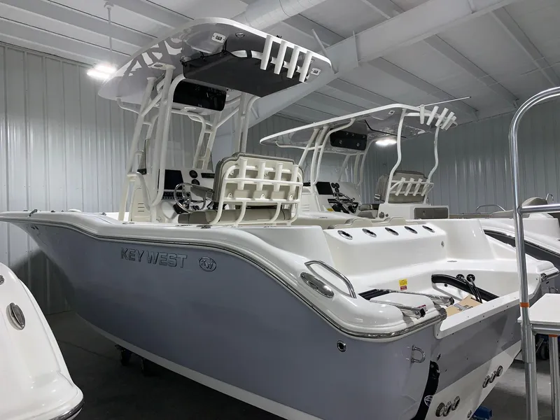 Slide: The Image of 2024 Key West 244 Center Console boat in a showroom. - 1