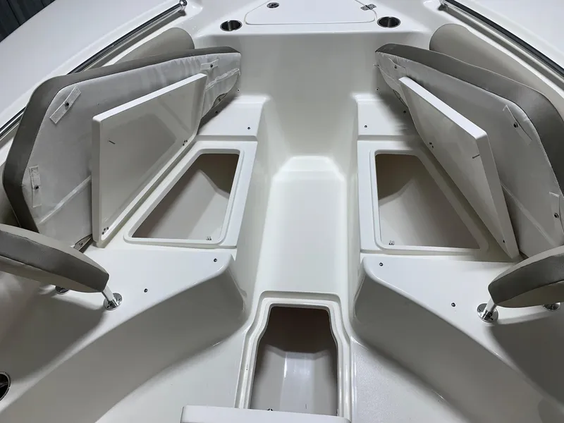 Slide: The Image of 2024 Key West 244 Center Console boat with open storage compartments and seating. - 13