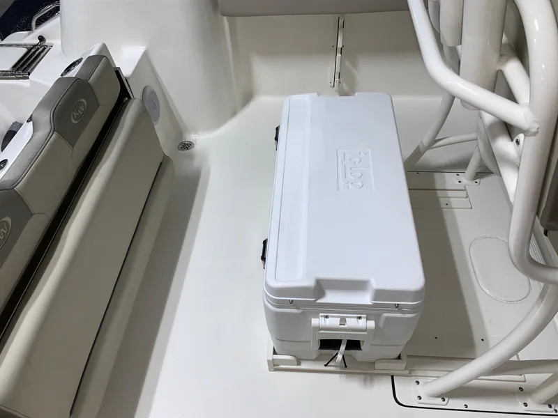 Slide: The Image of 2024 Key West 244 Center Console boat interior with cooler and seating. - 7