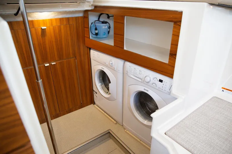 Slide: The Image of Laundry area in 2025 Ranger Tugs R-43 Command Bridge Luxury Edition yacht. - 20