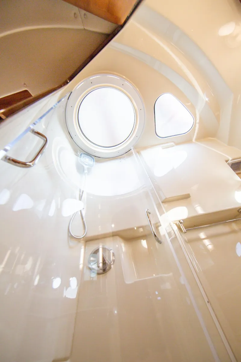 Slide: The Image of Interior of 2025 Ranger Tugs R-43 Sedan yacht bathroom with porthole window. - 16
