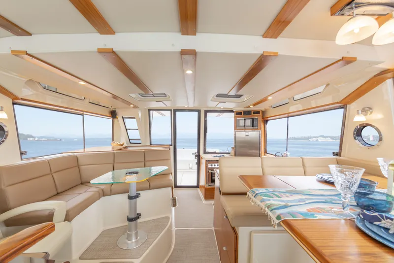 Slide: The Image of Luxurious interior of 2025 Ranger Tugs R-43 Sedan with ocean view. - 3