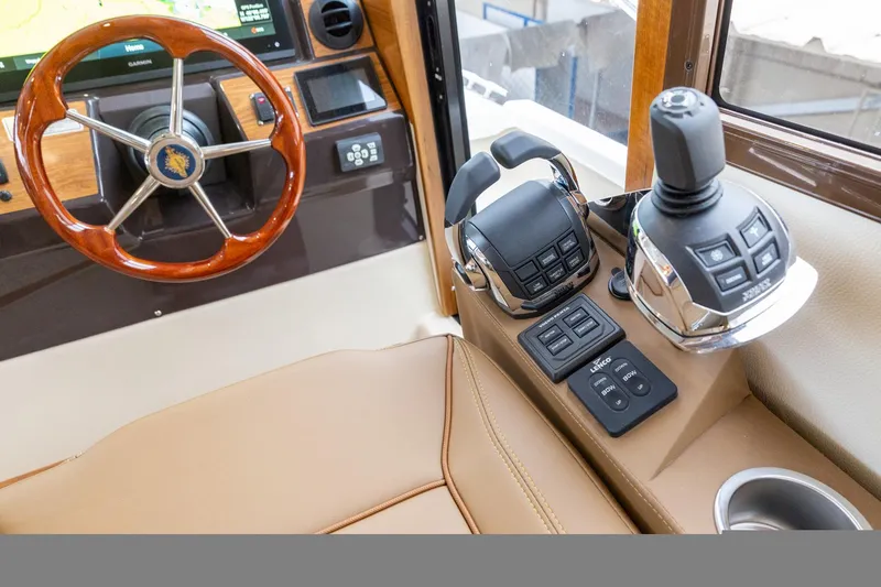 Slide: The Image of Interior helm of 2025 Ranger Tugs R-43 Sedan with steering wheel and controls. - 6