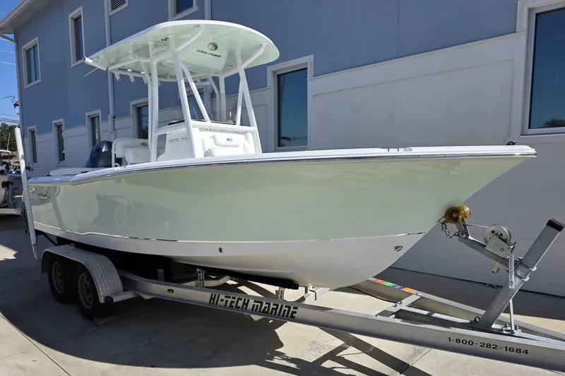 Slide: The Image of 2019 Sea Hunt Ultra 211 boat on trailer, parked near a building. - 1