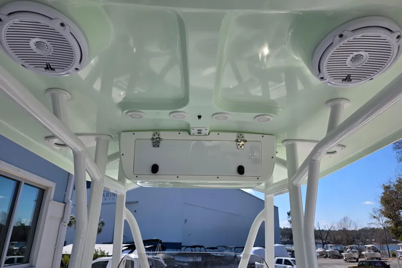 Slide: The Image of 2019 Sea Hunt Ultra 211 boat interior with speakers and storage compartment. - 10