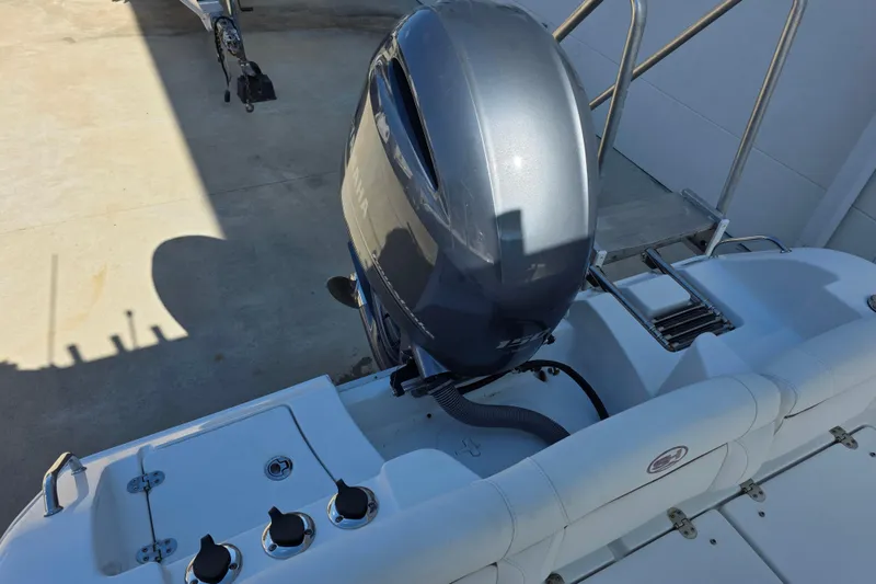 Slide: The Image of 2019 Sea Hunt Ultra 211 boat with Yamaha outboard motor and swim ladder. - 14