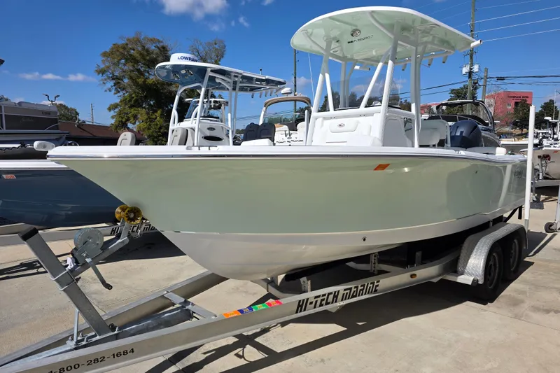 Slide: The Image of 2019 Sea Hunt Ultra 211 boat on trailer, displayed outdoors under clear sky. - 2