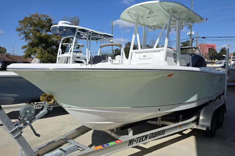 Slide: The Image of 2019 Sea Hunt Ultra 211 boat on trailer, displayed outdoors under clear blue sky. - 3