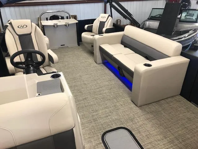 Slide: The Image of 2023 Harris Cruiser 230 interior with beige seating and blue LED lighting. - 6