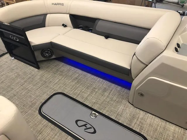 Slide: The Image of 2023 Harris Cruiser 230 interior with beige seating and blue LED lighting. - 8