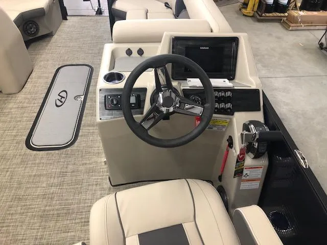 Slide: The Image of 2023 Harris Cruiser 230 boat interior with steering wheel and control panel. - 9