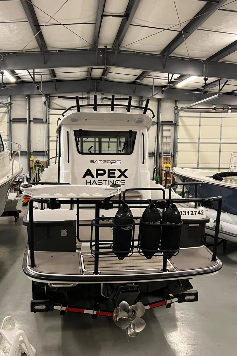 Slide: The Image of 2021 Sargo 25 boat in a storage facility with APEX HASTINGS on the back. - 13