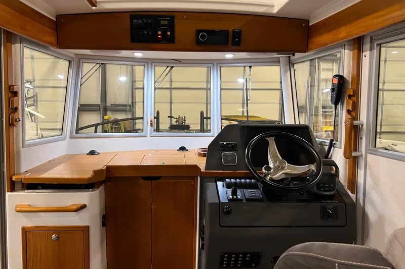 Slide: The Image of Interior helm of 2021 Sargo 25 boat with wooden accents and modern controls. - 18