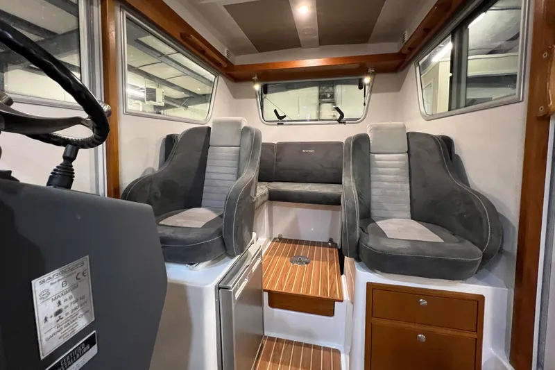 Slide: The Image of Interior of 2021 Sargo 25 boat with plush seating and wooden accents. - 20