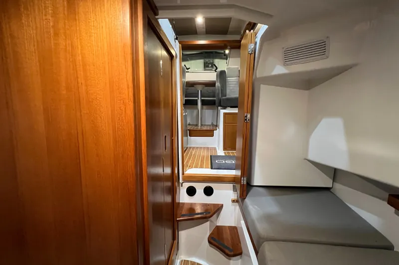 Slide: The Image of Interior cabin of 2021 Sargo 25 boat with wooden finishes and seating area. - 24