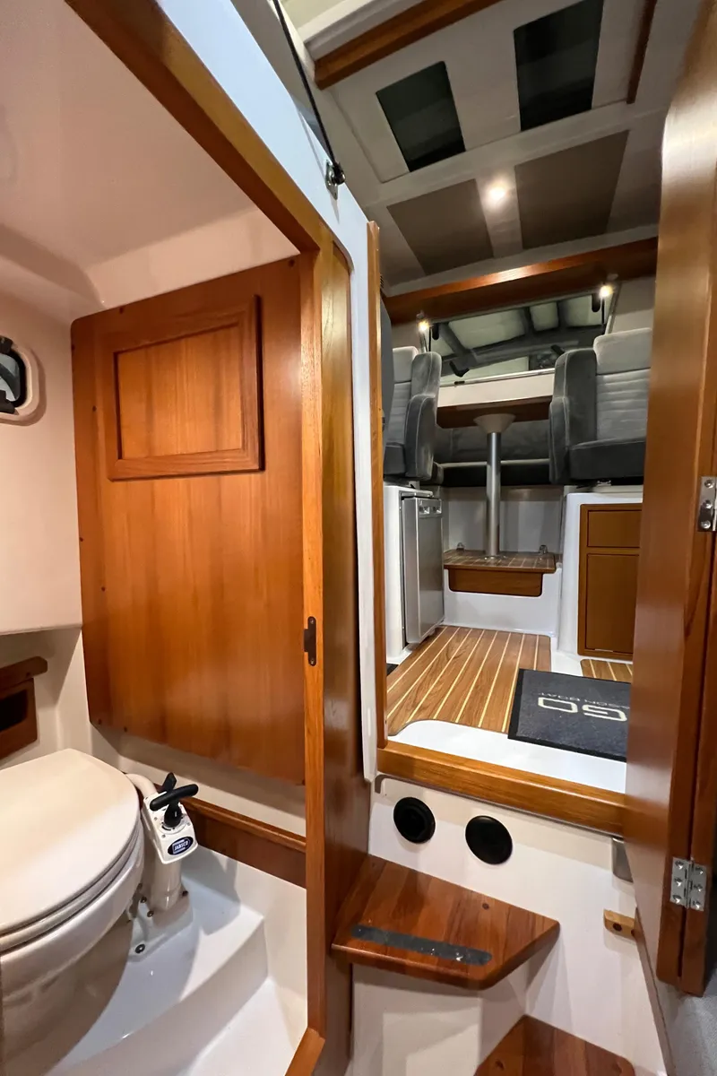 Slide: The Image of Interior of 2021 Sargo 25 boat with wooden finishes and compact bathroom. - 29