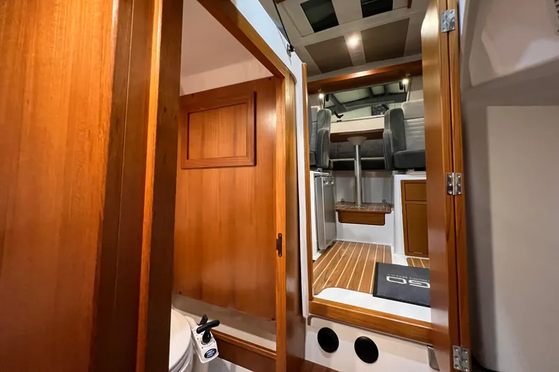 Slide: The Image of Interior of 2021 Sargo 25 boat with wooden finishes and modern seating. - 30