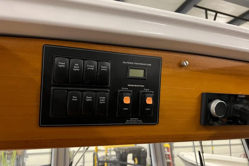 Slide: The Image of Control panel of a 2021 Sargo 25 boat with various switches and temperature display. - 34