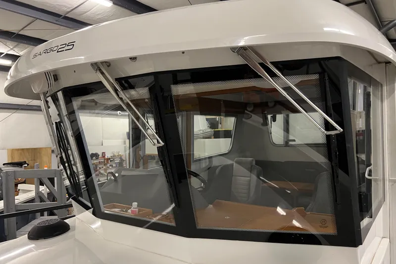 Slide: The Image of 2021 Sargo 25 boat interior view through front windows in a storage facility. - 35
