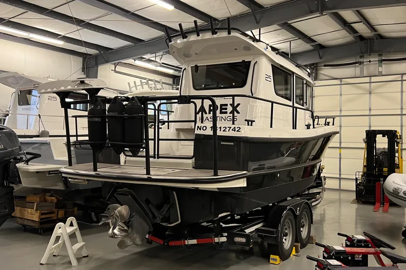 Slide: The Image of 2021 Sargo 25 boat on trailer in indoor storage facility. - 41