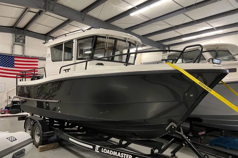 Slide: The Image of 2021 Sargo 25 boat on Loadmaster trailer in indoor storage facility. - 5