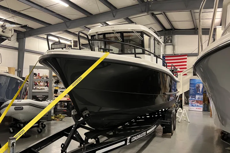 Slide: The Image of 2021 Sargo 25 boat on Loadmaster trailer in indoor storage facility. - 6