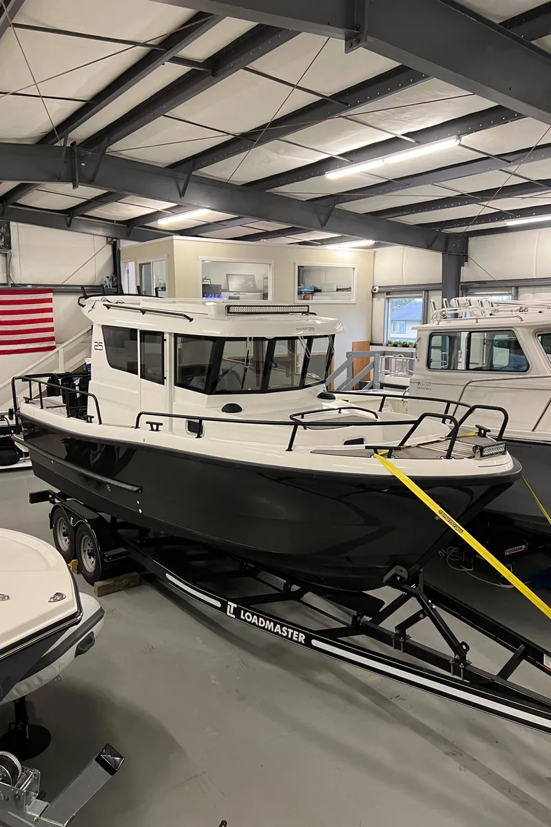 Slide: The Image of 2021 Sargo 25 boat on Loadmaster trailer in indoor showroom. - 8
