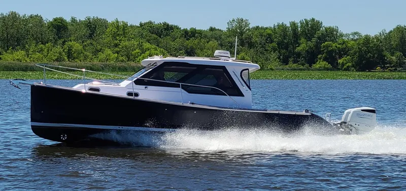 The Image of True North 34 Outboard Express 2026 on a lake. - 0