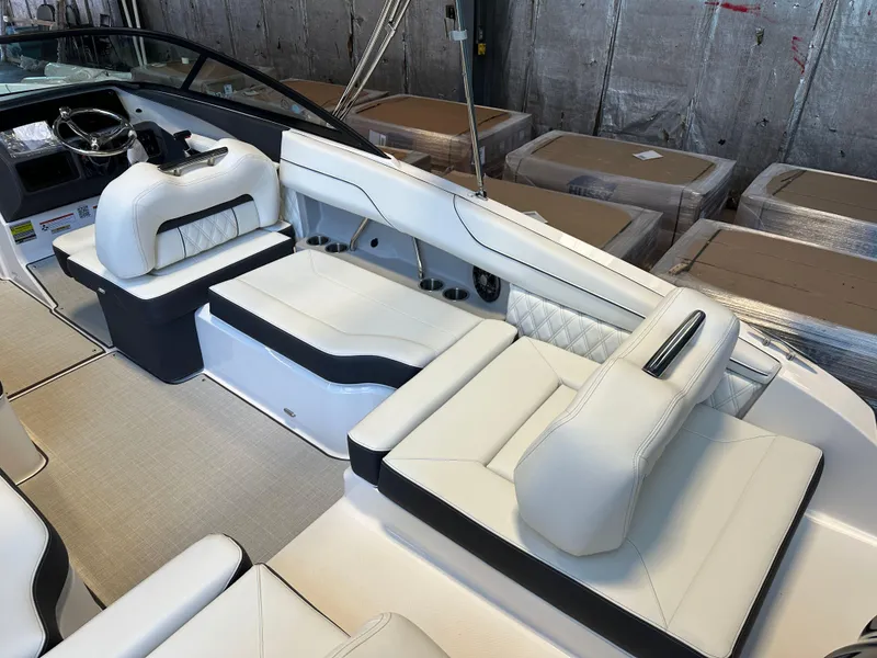 Slide: The Image of 2025 Regal LX2 boat in showroom with powerful outboard motor. - 6