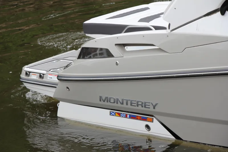 Slide: The Image of 2021 Monterey 298SS Super Sport boat interior with white seating and speakers. - 11