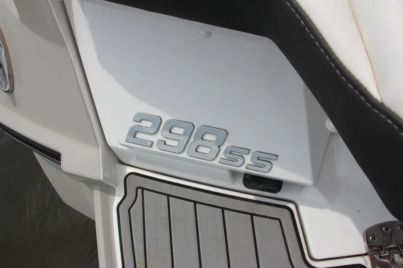 Slide: The Image of 2021 Monterey 298 SS boat on calm water, featuring sleek design and spacious seating. - 16