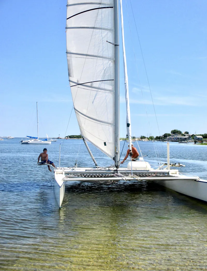 Slide: The Image of Sailboat Aquarius RC 27, 1981 model, sailing in shallow waters on a sunny day. - 8