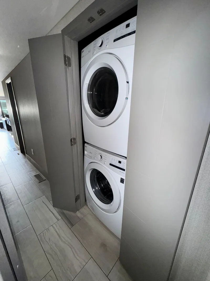 Slide: The Image of Stacked washer and dryer in a modern laundry closet, Adonia Just Add Water Trip #13, 2021. - 12