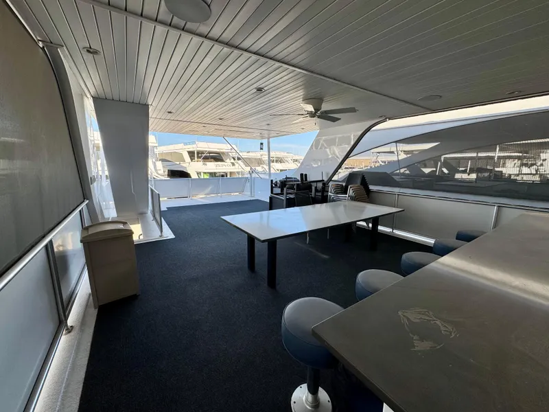 Slide: The Image of Spacious deck area on Adonia Just Add Water Trip #13, featuring tables and seating, 2021. - 18