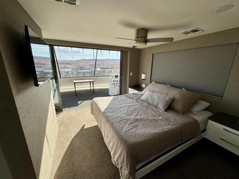 Slide: The Image of Modern bedroom with large windows, neutral decor, and scenic view. Adonia Just Add Water Trip #13, 2021. - 21