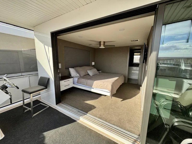 Slide: The Image of Modern bedroom on Adonia Just Add Water Trip #13 houseboat, featuring open sliding doors and cozy interior. - 23