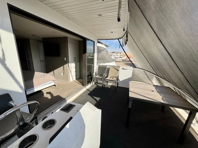 Slide: The Image of Modern houseboat interior with open deck, seating, and bedroom view, Adonia Just Add Water Trip #13, 2021. - 24