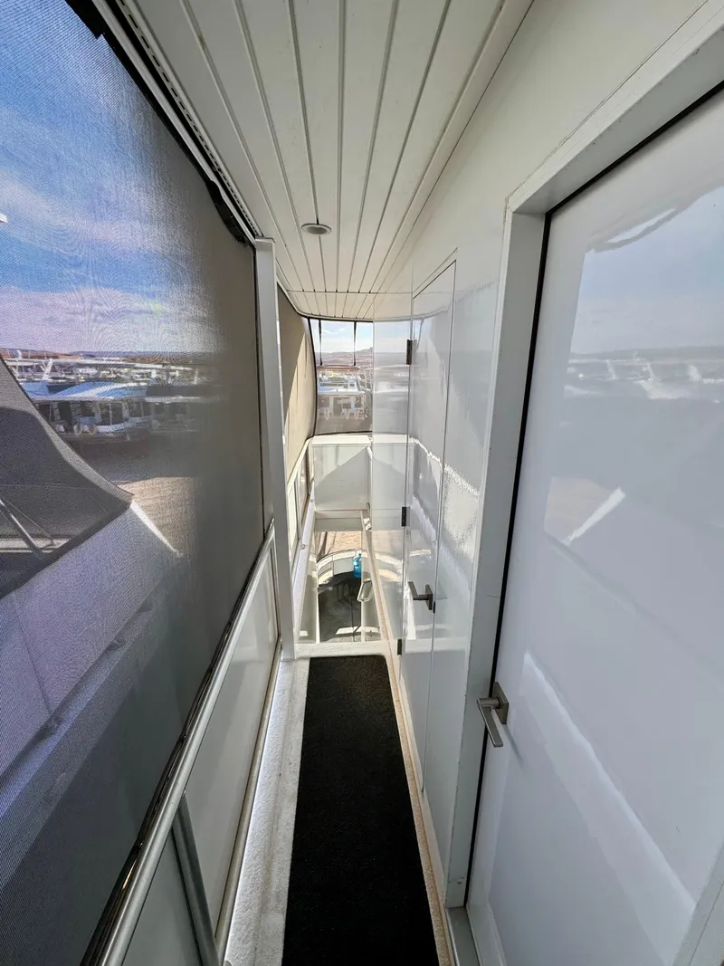 Slide: The Image of Narrow boat corridor with white walls, glass railing, and outdoor view, Adonia Just Add Water Trip 2021. - 25