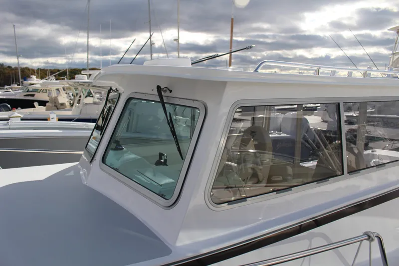 Slide: The Image of 2024 Steiger Craft 31 Miami boat at marina, close-up of cabin and windows. - 10