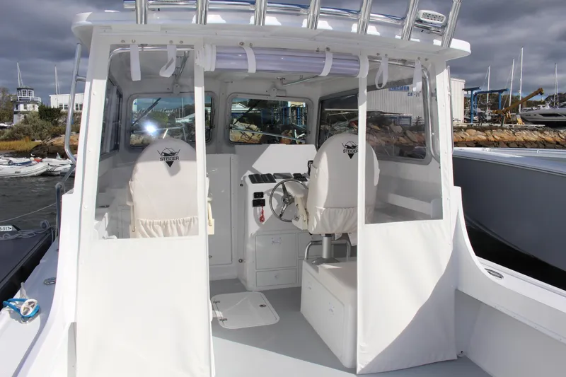 Slide: The Image of 2024 Steiger Craft 31 Miami boat cockpit with helm and seating. - 12