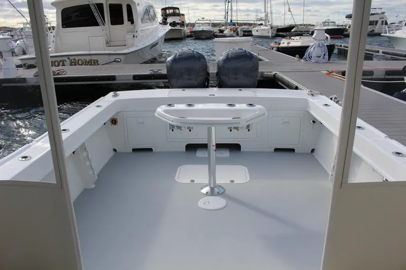 Slide: The Image of 2024 Steiger Craft 31 Miami boat docked at a marina, featuring a spacious deck. - 13