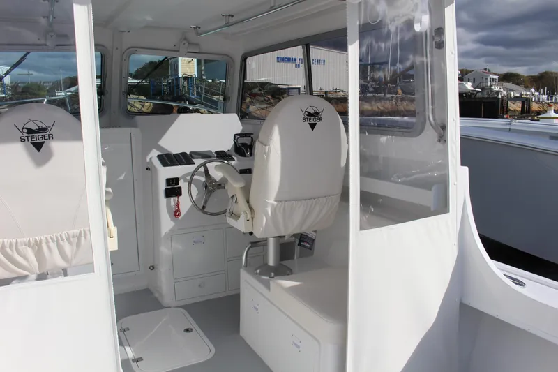 Slide: The Image of 2024 Steiger Craft 31 Miami boat interior with steering wheel and seating. - 15