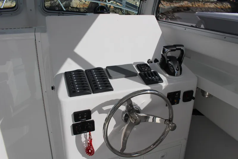 Slide: The Image of Steiger Craft 31 Miami 2024 boat helm with steering wheel and control panel. - 19