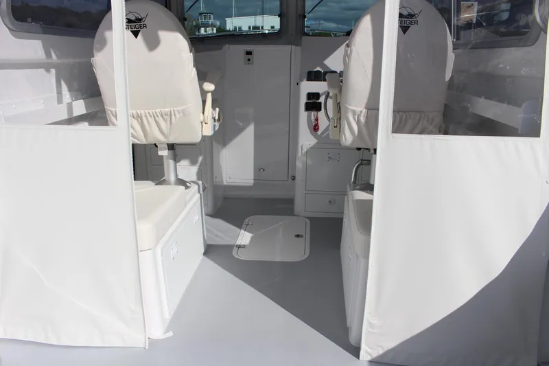 Slide: The Image of 2024 Steiger Craft 31 Miami boat interior with white seating and storage compartments. - 20