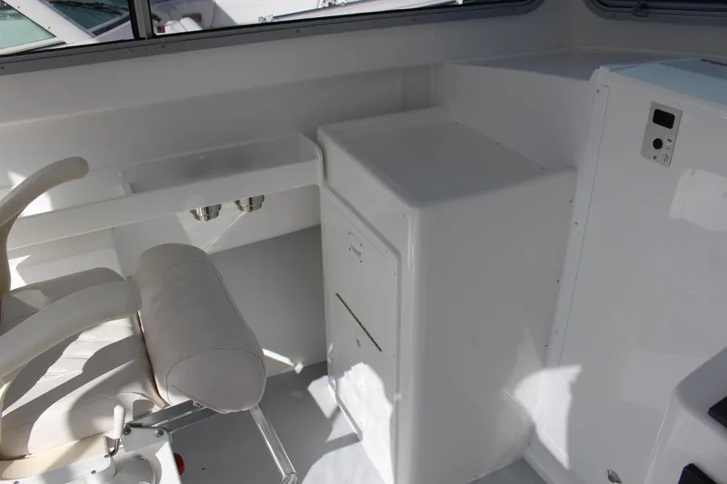 Slide: The Image of Interior of 2024 Steiger Craft 31 Miami boat with white seating and storage. - 24