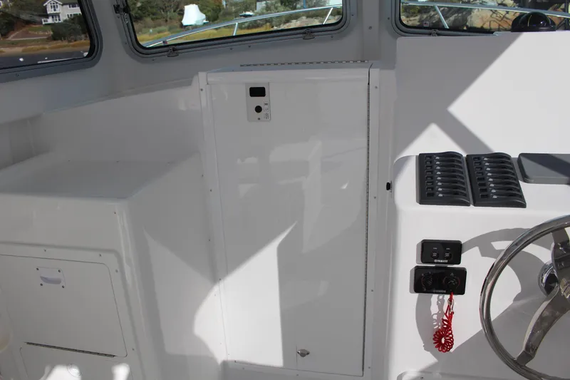 Slide: The Image of 2024 Steiger Craft 31 Miami boat interior with control panel and steering wheel. - 27
