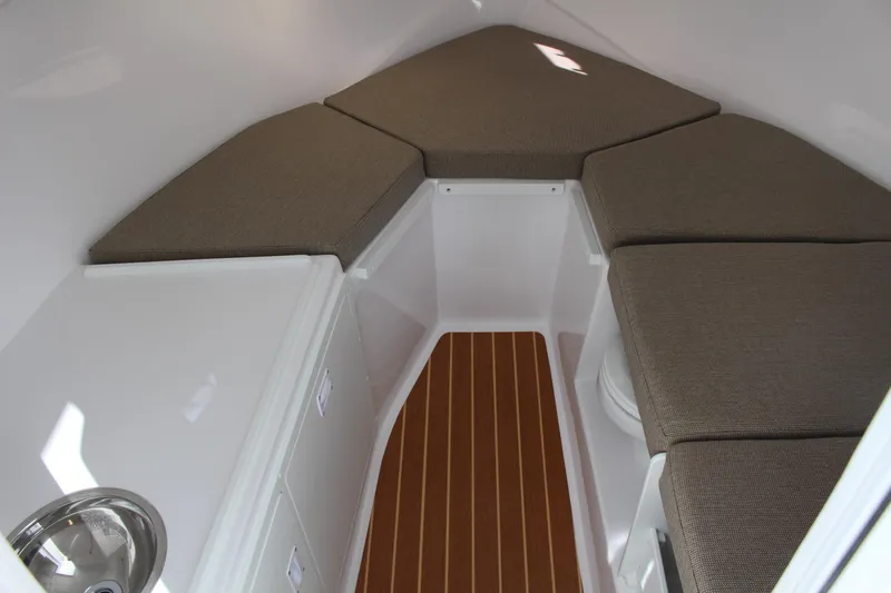 Slide: The Image of 2024 Steiger Craft 31 Miami cabin interior with cushioned seating and wood flooring. - 28